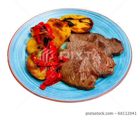 Tasty veal baked with potatoes and peppers served at plate Tasty veal baked with potatoes and peppers served at plate 68112041