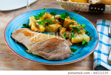 Roasted pork chop with grilled potatoes garnish Roasted pork chop with grilled potatoes garnish 68112135
