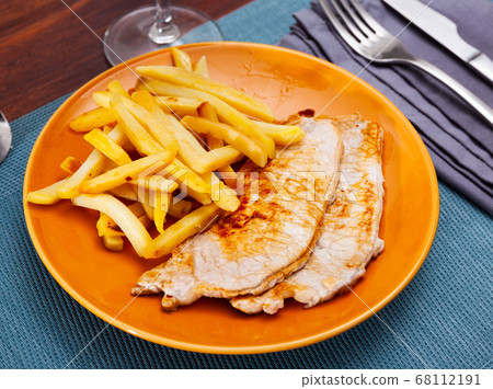 Homemade baked pork chops with French fries Homemade baked pork chops with French fries 68112191