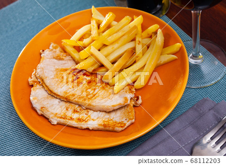 Appetizing fried pork with potatoes and herbs Appetizing fried pork with potatoes and herbs 68112203