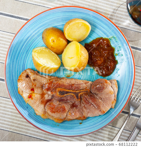Served dish with fried pork, herbs and potatoes Served dish with fried pork, herbs and potatoes 68112222