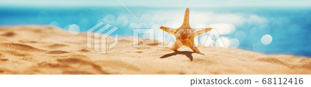 Blurred sea background with beautiful bokeh and sand on foreground Blurred sea background with beautiful bokeh and sand on foreground 68112416