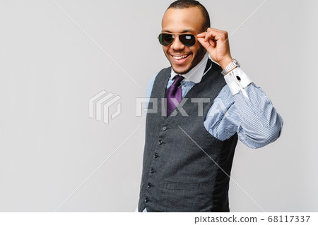 Studio shot of young African-American businessmanman over grey background 68117337