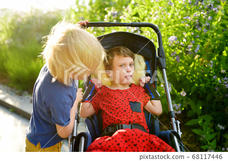Little boy and disabled girl in a wheelchair 68117446
