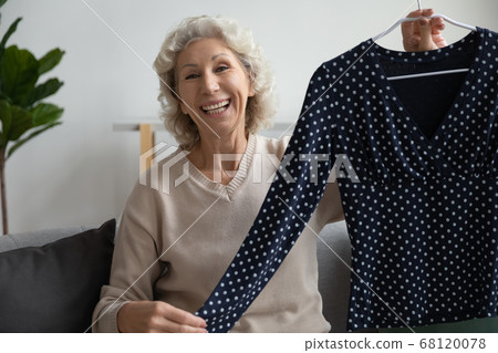 Elderly woman blogger share brand new wear showing blouse smiling 68120078