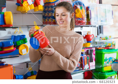 woman buyer with children's plastic toys woman buyer with children's plastic toys 68120323