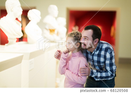 Father and daughter looking at classical statues Father and daughter looking at classical statues 68120508