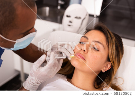 Latina receiving injections for face skin tightening in cosmetology clinic Latina receiving injections for face skin tightening in cosmetology clinic 68120802
