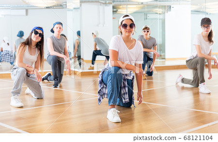 Teens hip hop dancers posing on knees 68121104