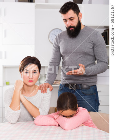 Father lecturing wife and daughter Father lecturing wife and daughter 68121367