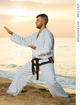 Man doing karate poses 68121425