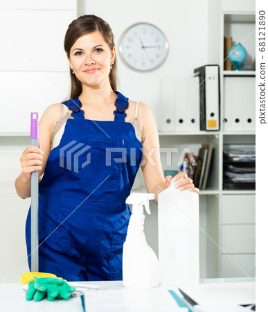 Young female cleaner in protective uniform at company office Young female cleaner in protective uniform at company office 68121890
