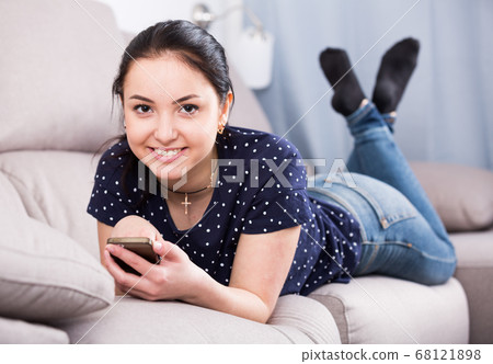Cheerful girl with mobile phone 68121898