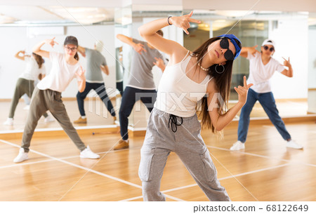 Teenagers boy and girls performing hip hop at group class Teenagers boy and girls performing hip hop at group class 68122649