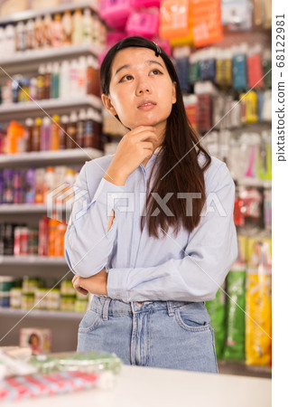 Asian woman in cosmetics store 68122981