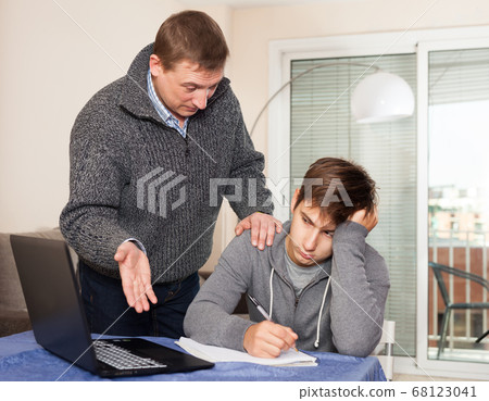 Father unhappy with how teenage son learns Father unhappy with how teenage son learns 68123041
