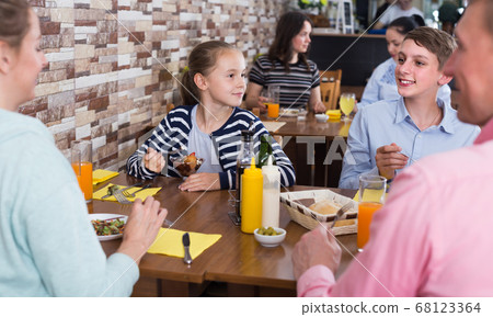 Happy family having lunch Happy family having lunch 68123364