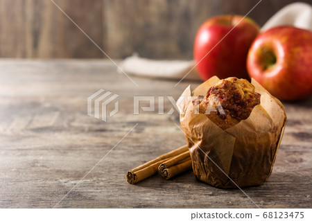Apples and cinnamon muffins on wooden table	 68123475