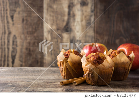 Apples and cinnamon muffins on wooden table	 68123477