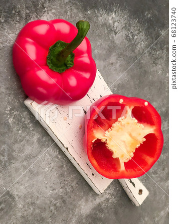 halved red bell pepper on a cutting board 68123740
