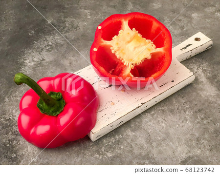halved red bell pepper on a cutting board halved red bell pepper on a cutting board 68123742