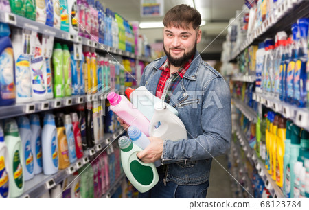 male standing with household chemicals 68123784