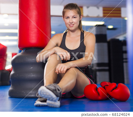 Woman is resting on the floor after training Woman is resting on the floor after training 68124024