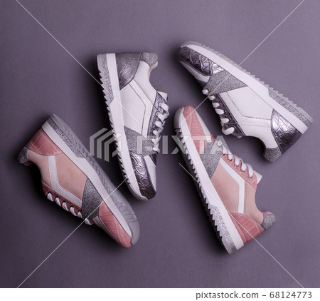 Trendy woman sneakers made of genuine leather and glitter elements. Fashionable women's sports footwear. 68124773