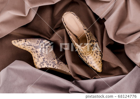 Women's high heeled ankle boot shoes made of Python Leather. Luxury leather shoes advertising backdrop. Women's high heeled ankle boot shoes made of Python Leather. Luxury leather shoes advertising backdrop. 68124776