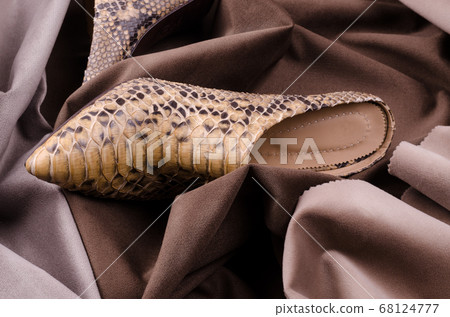 Women's high heeled ankle boot shoes made of Python Leather. Luxury leather shoes advertising backdrop. Women's high heeled ankle boot shoes made of Python Leather. Luxury leather shoes advertising backdrop. 68124777