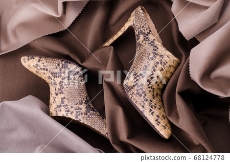 Women's high heeled ankle boot shoes made of Python Leather. Luxury leather shoes advertising backdrop. Women's high heeled ankle boot shoes made of Python Leather. Luxury leather shoes advertising backdrop. 68124778