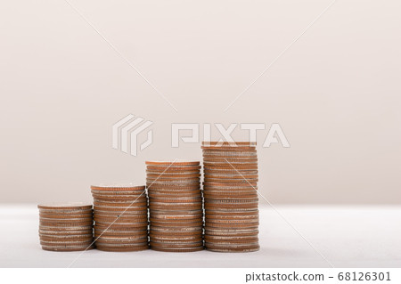 Hand putting coins on stack on table,Saving money 68126301