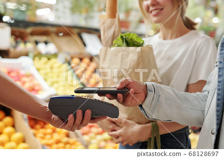 Paying with smartphone at market Paying with smartphone at market 68128697