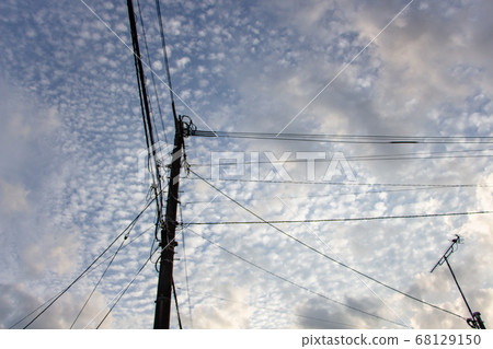 Sky and utility poles Utility poles and electric wires against the blue sky Sky and utility poles Utility poles and electric wires against the blue sky 68129150