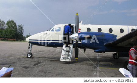 Passenger plane preparing for departure to Pokhara, Kathmandu Airport, Nepal Passenger plane preparing for departure to Pokhara, Kathmandu Airport, Nepal 68129885