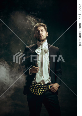 Young man as Dorian Gray on dark background. Retro style, comparison of eras concept. 68129992