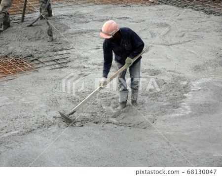 KUALA LUMPUR, MALAYSIA -SEPTEMBER 05, 2017: Construction workers leveling wet concrete has been poured. They also using long trowel for this job. KUALA LUMPUR, MALAYSIA -SEPTEMBER 05, 2017: Construction workers leveling wet concrete has been poured. They also using long trowel for this job. 68130047