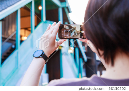 Woman shooting on Nagasaki Dejima smartphone Woman shooting on Nagasaki Dejima smartphone 68130202
