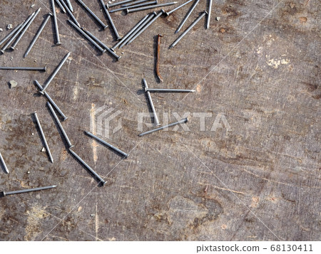 Nails are randomly scattered over ply wood Nails are randomly scattered over ply wood 68130411