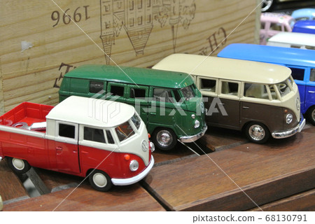KUALA LUMPUR, MALAYSIA -DECEMBER 16, 2016: Miniature model of Volkswagen vans from Combi series on wood texture board background.  68130791