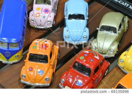 KUALA LUMPUR, MALAYSIA -DECEMBER 16, 2016: Miniature model of Volkswagen Beetle on wood texture board background. KUALA LUMPUR, MALAYSIA -DECEMBER 16, 2016: Miniature model of Volkswagen Beetle on wood texture board background. 68130896