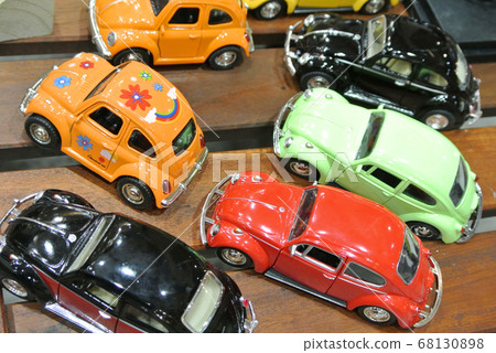 KUALA LUMPUR, MALAYSIA -DECEMBER 16, 2016: Miniature model of Volkswagen Beetle on wood texture board background.  68130898