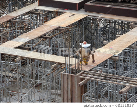 KUALA LUMPUR, MALAYSIA -NOVEMBER 11, 2016: Metal scaffolding used as temporary structure to support slab timber form work at the construction site. Able to adjust to get required level.    68131037