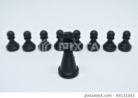 Black chess pieces all together arranged randomly on white background. Black chess pieces all together arranged randomly on white background. 68131083