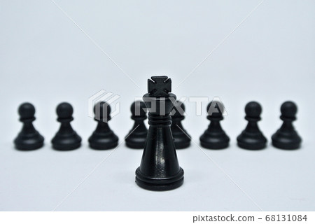 Black chess pieces all together arranged randomly on white background. Black chess pieces all together arranged randomly on white background. 68131084