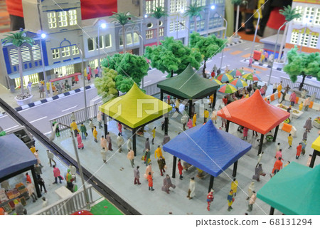 KUALA LUMPUR, MALAYSIA -NOVEMBER 26, 2017: Miniature model of urban park in the middle of city. Miniature model of hawkers stall, visitor and landscape.  68131294