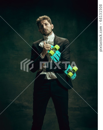 Young man as Dorian Gray on dark background. Retro style, comparison of eras concept. 68131508