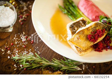 Pike-perch fillet. Asparagus, pearl couscous, white wine sauce, beet-flavored mashed potatoes. Delicious seafood fish closeup served on a table for lunch in modern cuisine gourmet restaurant Pike-perch fillet. Asparagus, pearl couscous, white wine sauce, beet-flavored mashed potatoes. Delicious seafood fish closeup served on a table for lunch in modern cuisine gourmet restaurant 68132254