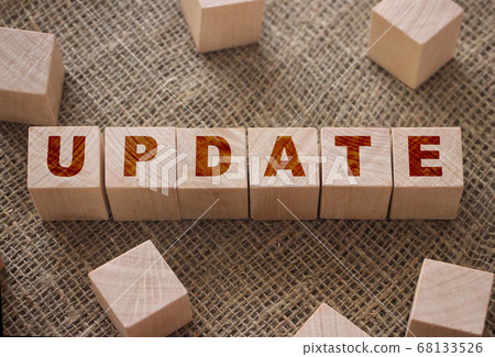 Update word on a wooden cubes on burlap canvas . Business technologies concept 68133526