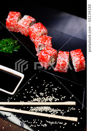 Sushi with salmon. Soy sauce, red caviar. Sushi on a black background. Sushi with salmon. Soy sauce, red caviar. Sushi on a black background. 68134188